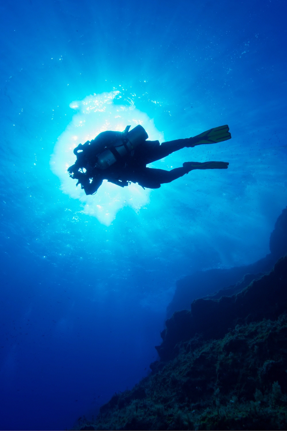 Diver silhouette against the sun